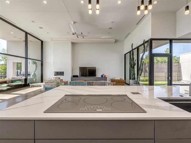 11300 N Westminster Rd, Jones, OK 73049 - kitchen with open floor plan, black electric stovetop, gray cabinetry, light stone counters, and recessed lighting