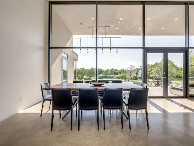 11300 N Westminster Rd, Jones, OK 73049 - dining area featuring concrete flooring, french doors, and a towering ceiling