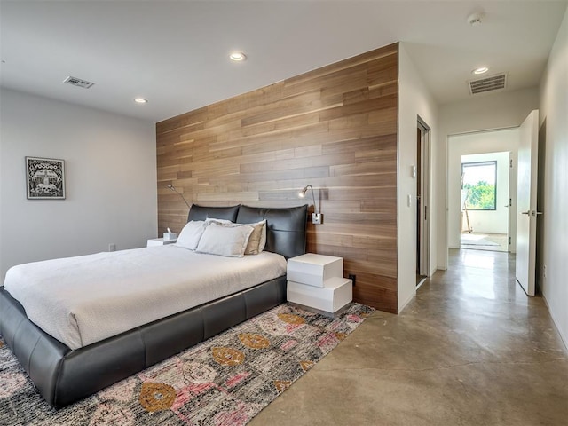 11300 N Westminster Rd, Jones, OK 73049 - bedroom featuring recessed lighting, wood walls, finished concrete flooring, and an accent wall