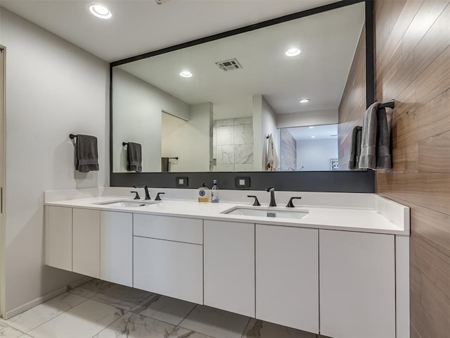 11300 N Westminster Rd, Jones, OK 73049 - full bathroom featuring marble look tile flooring, double vanity, and recessed lighting