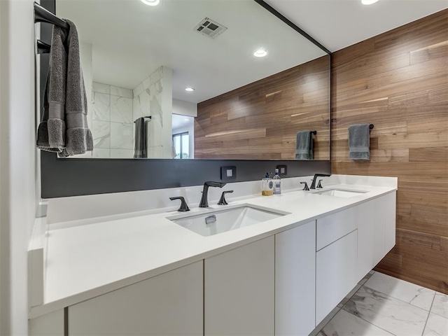 11300 N Westminster Rd, Jones, OK 73049 - full bathroom featuring double vanity, recessed lighting, wood walls, and marble finish floors