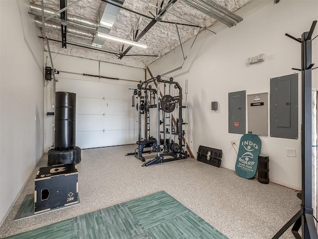 11300 N Westminster Rd, Jones, OK 73049 - workout area featuring electric panel, a garage, and a towering ceiling