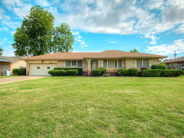 513 SW 57th St, Oklahoma City, OK 73109 - single story home with brick siding, a garage, driveway, and a front yard