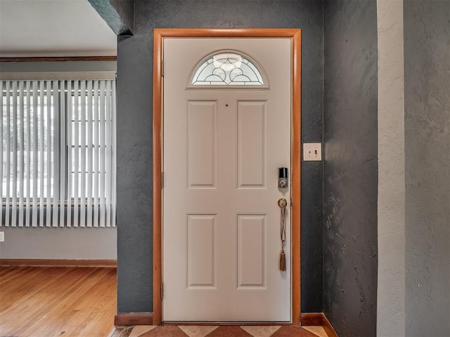 513 SW 57th St, Oklahoma City, OK 73109 - foyer entrance featuring baseboards, wood finished floors, a textured wall, and ornamental molding