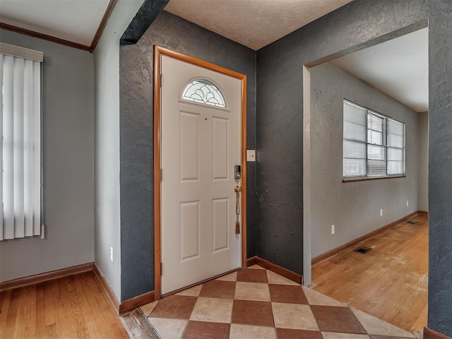 513 SW 57th St, Oklahoma City, OK 73109 - foyer entrance with plenty of natural light, light wood-style flooring, baseboards, and crown molding