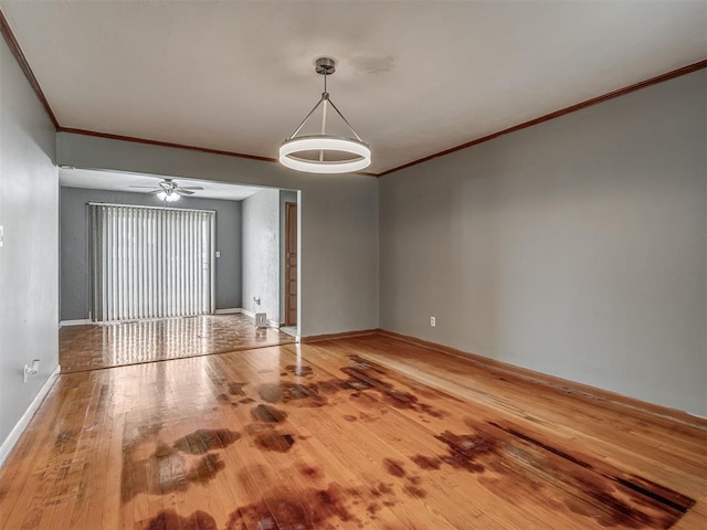 513 SW 57th St, Oklahoma City, OK 73109 - spare room with wood finished floors, crown molding, baseboards, and a ceiling fan