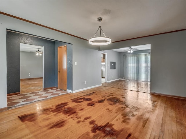 513 SW 57th St, Oklahoma City, OK 73109 - unfurnished room with a ceiling fan, crown molding, hardwood / wood-style floors, and baseboards