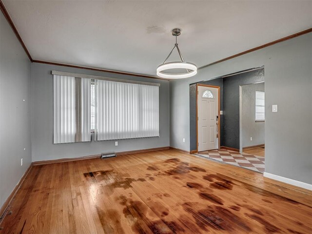 513 SW 57th St, Oklahoma City, OK 73109 - entrance foyer with ornamental molding, baseboards, and wood finished floors