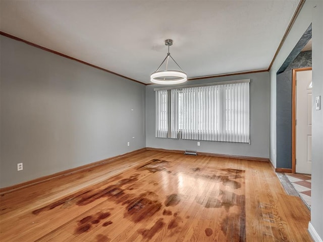 513 SW 57th St, Oklahoma City, OK 73109 - unfurnished room featuring light wood-type flooring, ornamental molding, and baseboards