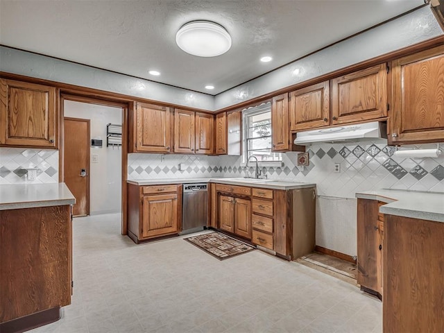 513 SW 57th St, Oklahoma City, OK 73109 - kitchen with under cabinet range hood, a sink, brown cabinetry, and recessed lighting