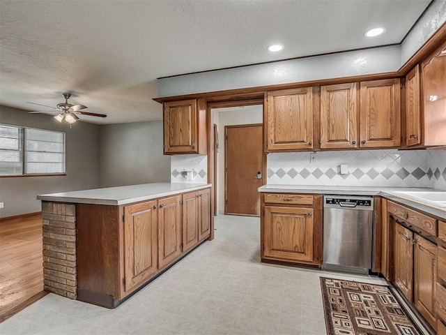 513 SW 57th St, Oklahoma City, OK 73109 - kitchen featuring stainless steel dishwasher, a ceiling fan, brown cabinetry, a peninsula, and recessed lighting