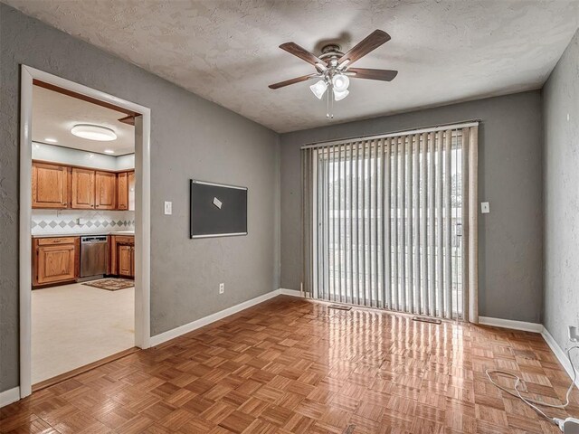 513 SW 57th St, Oklahoma City, OK 73109 - unfurnished room with ceiling fan, baseboards, and a textured ceiling