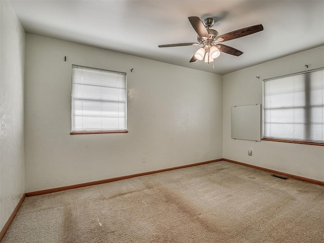 513 SW 57th St, Oklahoma City, OK 73109 - carpeted spare room featuring baseboards and a ceiling fan