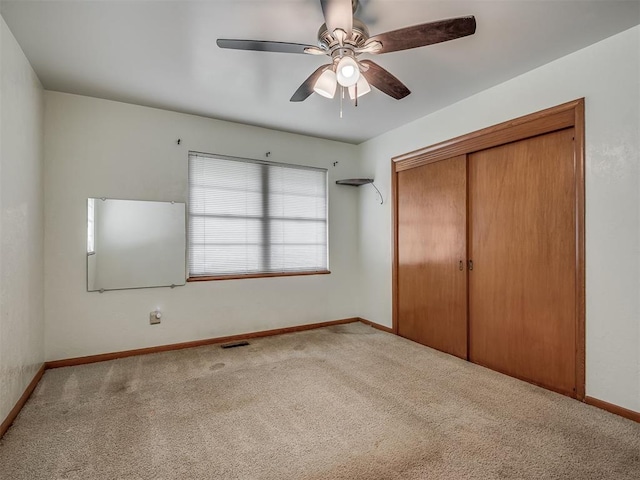 513 SW 57th St, Oklahoma City, OK 73109 - unfurnished bedroom featuring carpet flooring, baseboards, a closet, and a ceiling fan