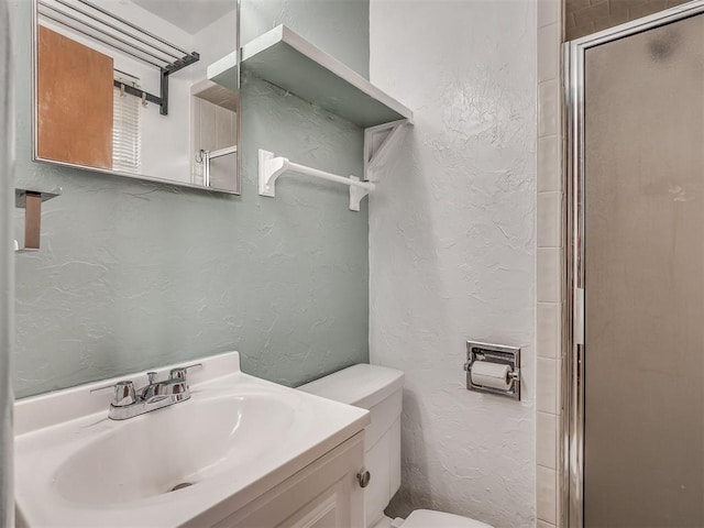 513 SW 57th St, Oklahoma City, OK 73109 - full bathroom with a stall shower, toilet, a textured wall, and vanity
