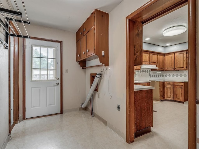 513 SW 57th St, Oklahoma City, OK 73109 - washroom featuring baseboards, hookup for an electric dryer, and cabinet space