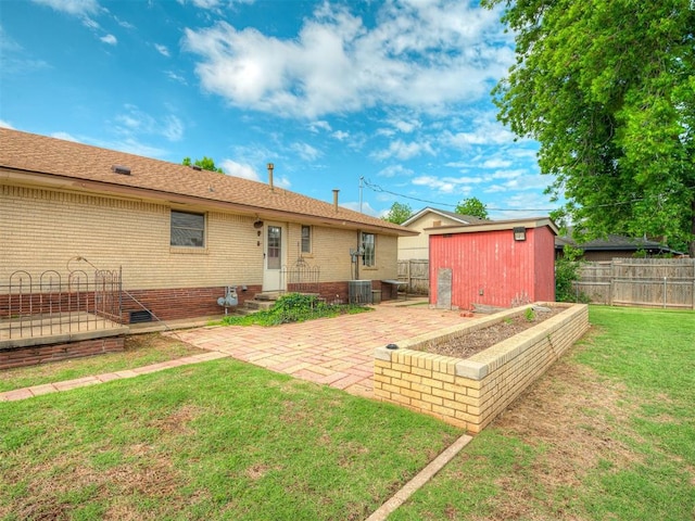 513 SW 57th St, Oklahoma City, OK 73109 - back of property with a patio, brick siding, and central AC