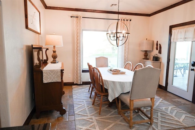 710 Isaiah Ln, Tuttle, OK 73089 - dining room with healthy amount of natural light, stone tile flooring, a chandelier, baseboards, and ornamental molding