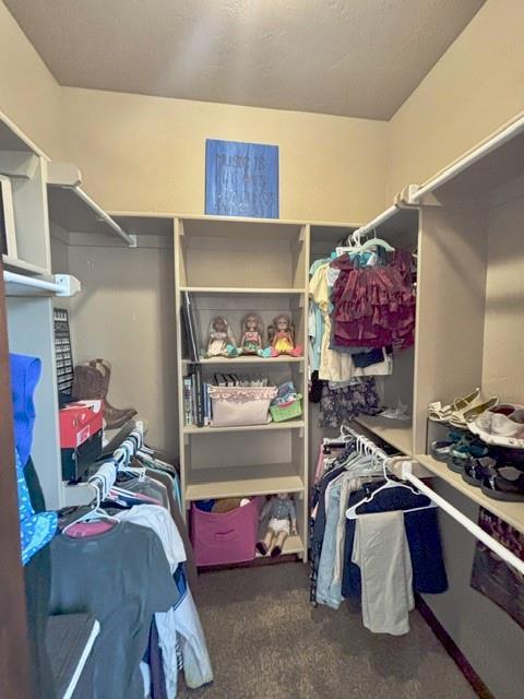 710 Isaiah Ln, Tuttle, OK 73089 - walk in closet featuring carpet floors