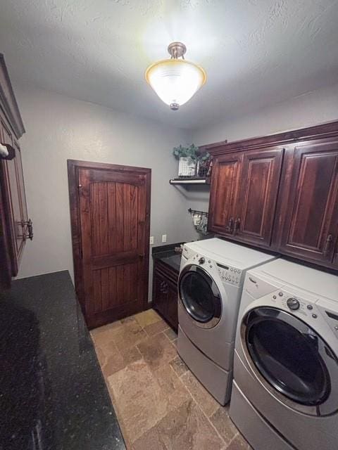 710 Isaiah Ln, Tuttle, OK 73089 - laundry area with washing machine and clothes dryer, cabinet space, and light stone finish flooring