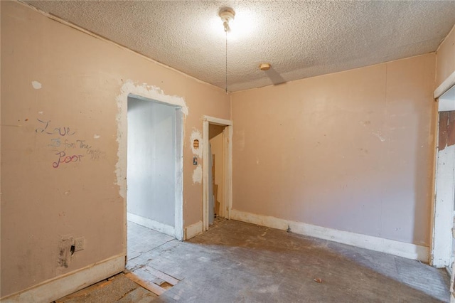 820 W Highland St, Shawnee, OK 74801 - unfurnished room featuring a textured ceiling