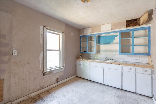 820 W Highland St, Shawnee, OK 74801 - kitchen featuring a sink, light countertops, and white cabinetry