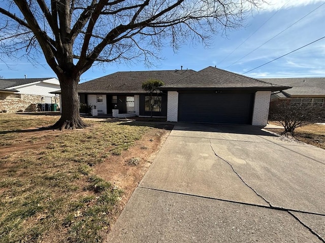 1908 NW 56th Ter, Oklahoma City, OK 73118 - ranch-style house with an attached garage, concrete driveway, and brick siding
