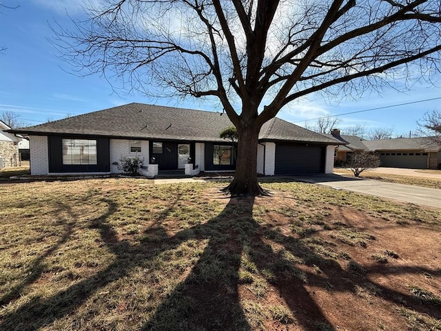 1908 NW 56th Ter, Oklahoma City, OK 73118 - ranch-style house featuring concrete driveway, an attached garage, and brick siding