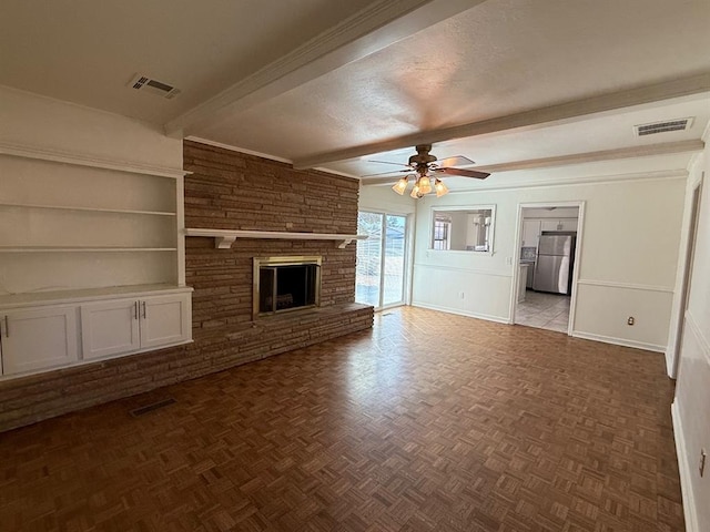 1908 NW 56th Ter, Oklahoma City, OK 73118 - unfurnished living room with beamed ceiling, ceiling fan, a fireplace, baseboards, and a textured ceiling