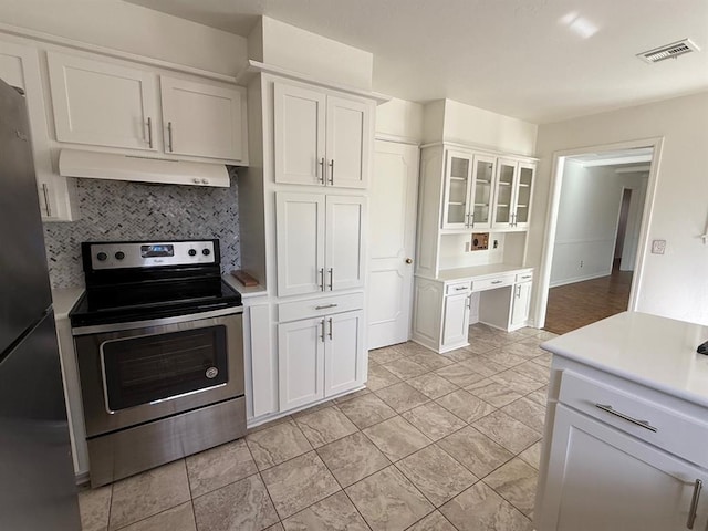 1908 NW 56th Ter, Oklahoma City, OK 73118 - kitchen with stainless steel appliances, decorative backsplash, white cabinetry, light countertops, and under cabinet range hood