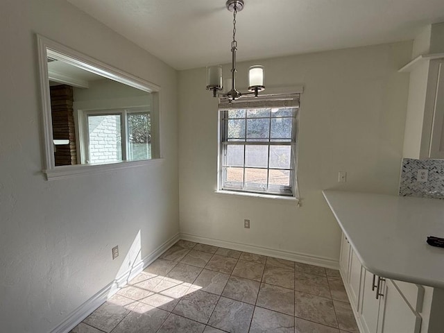 1908 NW 56th Ter, Oklahoma City, OK 73118 - unfurnished dining area featuring a chandelier and baseboards