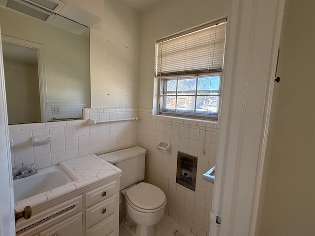 1908 NW 56th Ter, Oklahoma City, OK 73118 - half bath featuring tile walls, toilet, vanity, heating unit, and tile patterned flooring