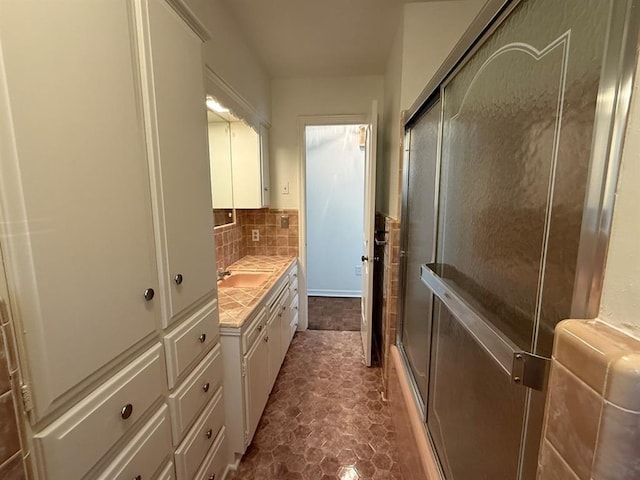 1908 NW 56th Ter, Oklahoma City, OK 73118 - full bathroom featuring vanity, a shower with door, and backsplash