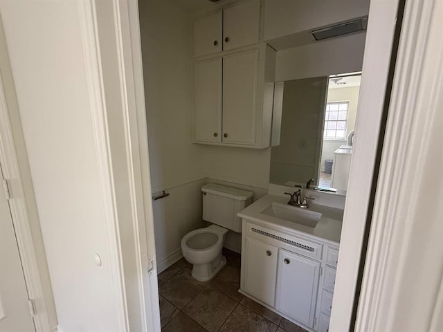1908 NW 56th Ter, Oklahoma City, OK 73118 - half bathroom featuring toilet, vanity, tile patterned flooring, and baseboards