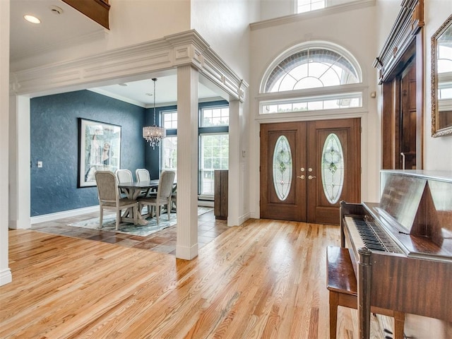 2508 Thunderwind Cir, Edmond, OK 73034 - entrance foyer with a chandelier, light wood-type flooring, ornamental molding, baseboards, and a towering ceiling