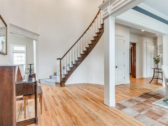 2508 Thunderwind Cir, Edmond, OK 73034 - entryway featuring wood finished floors, stairway, baseboards, and a towering ceiling