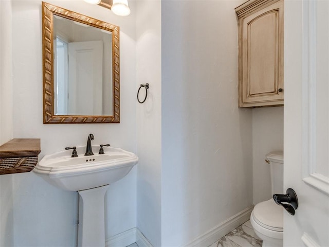 2508 Thunderwind Cir, Edmond, OK 73034 - half bathroom featuring marble look tile flooring, toilet, and baseboards