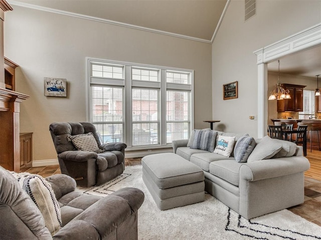 2508 Thunderwind Cir, Edmond, OK 73034 - living area featuring a chandelier, high vaulted ceiling, crown molding, and baseboards