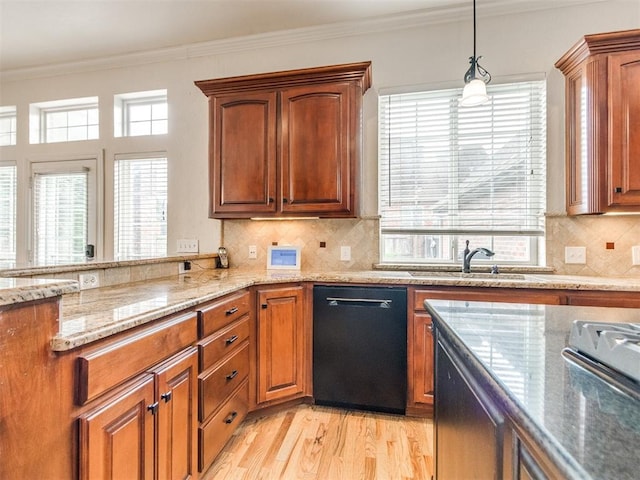 2508 Thunderwind Cir, Edmond, OK 73034 - kitchen with black dishwasher, light stone counters, ornamental molding, light wood-type flooring, and decorative light fixtures