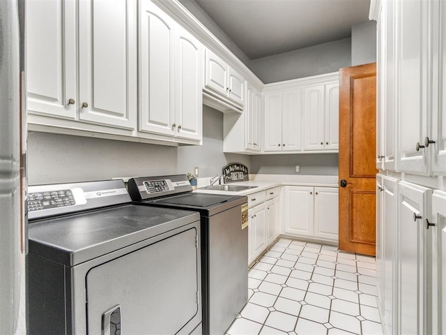 2508 Thunderwind Cir, Edmond, OK 73034 - laundry room with washer and dryer, cabinet space, and light tile patterned flooring