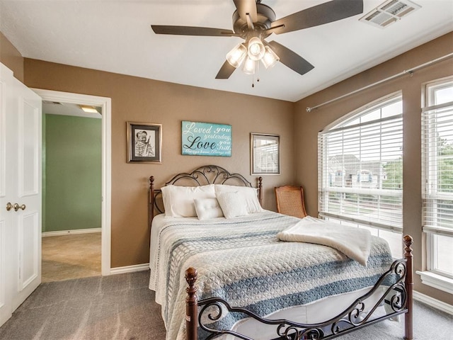 2508 Thunderwind Cir, Edmond, OK 73034 - bedroom featuring carpet floors, baseboards, multiple windows, and ceiling fan