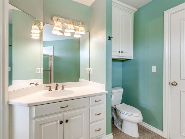 2508 Thunderwind Cir, Edmond, OK 73034 - bathroom with toilet, vanity, tile patterned floors, and baseboards