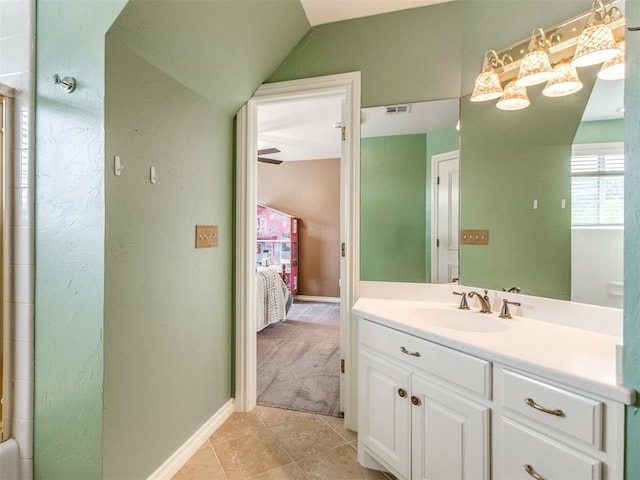 2508 Thunderwind Cir, Edmond, OK 73034 - ensuite bathroom featuring vanity, lofted ceiling, tile patterned floors, and baseboards