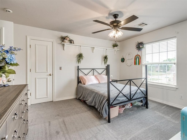 2508 Thunderwind Cir, Edmond, OK 73034 - bedroom featuring light carpet, baseboards, and a ceiling fan