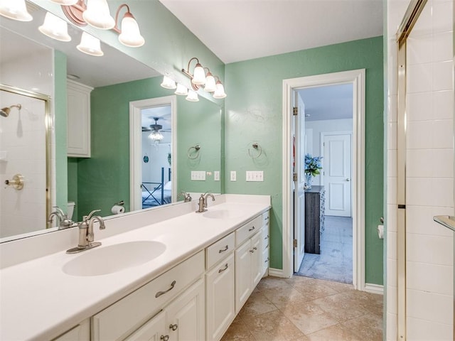 2508 Thunderwind Cir, Edmond, OK 73034 - bathroom featuring double vanity, a shower stall, a ceiling fan, and tile patterned floors