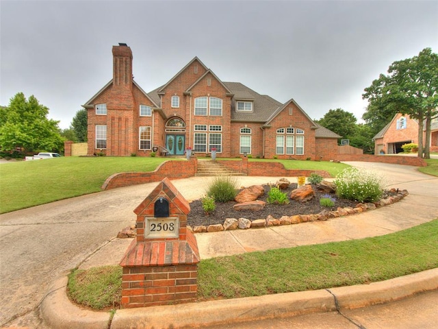 2508 Thunderwind Cir, Edmond, OK 73034 - view of front of home with a front yard and brick siding