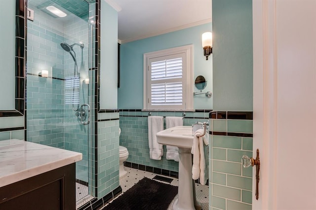 915 NW 40th St, Oklahoma City, OK 73118 - bathroom featuring tile walls, a shower stall, ornamental molding, toilet, and tile patterned flooring