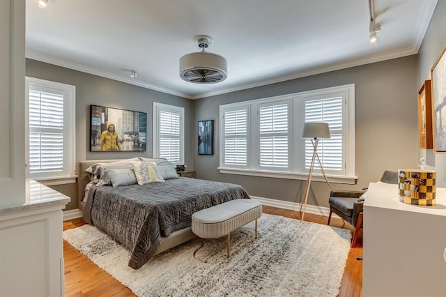 915 NW 40th St, Oklahoma City, OK 73118 - bedroom with light wood-style floors, crown molding, and baseboards