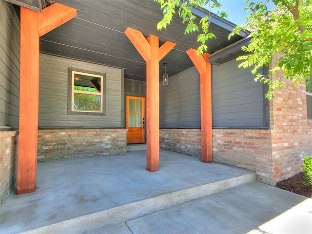 11508 NW 102nd St, Yukon, OK 73099 - view of exterior entry featuring brick siding and covered porch