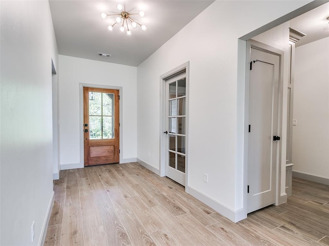 11508 NW 102nd St, Yukon, OK 73099 - foyer entrance with a chandelier, light wood finished floors, and baseboards